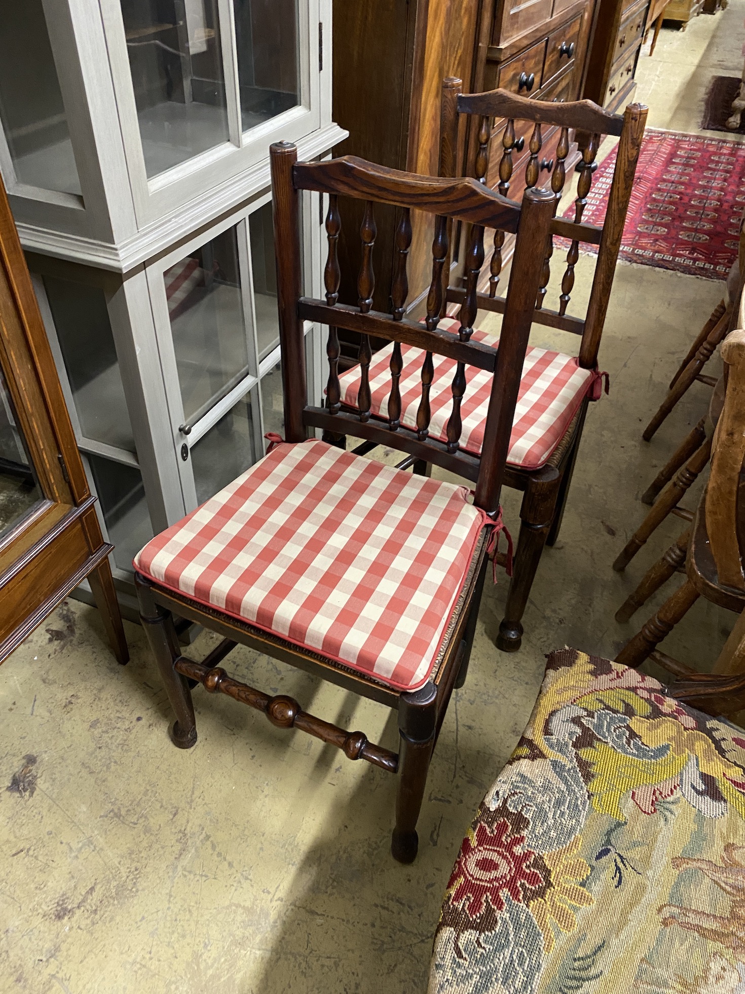 A set of eight Lancashire rush seat spindle back dining chairs, and one other